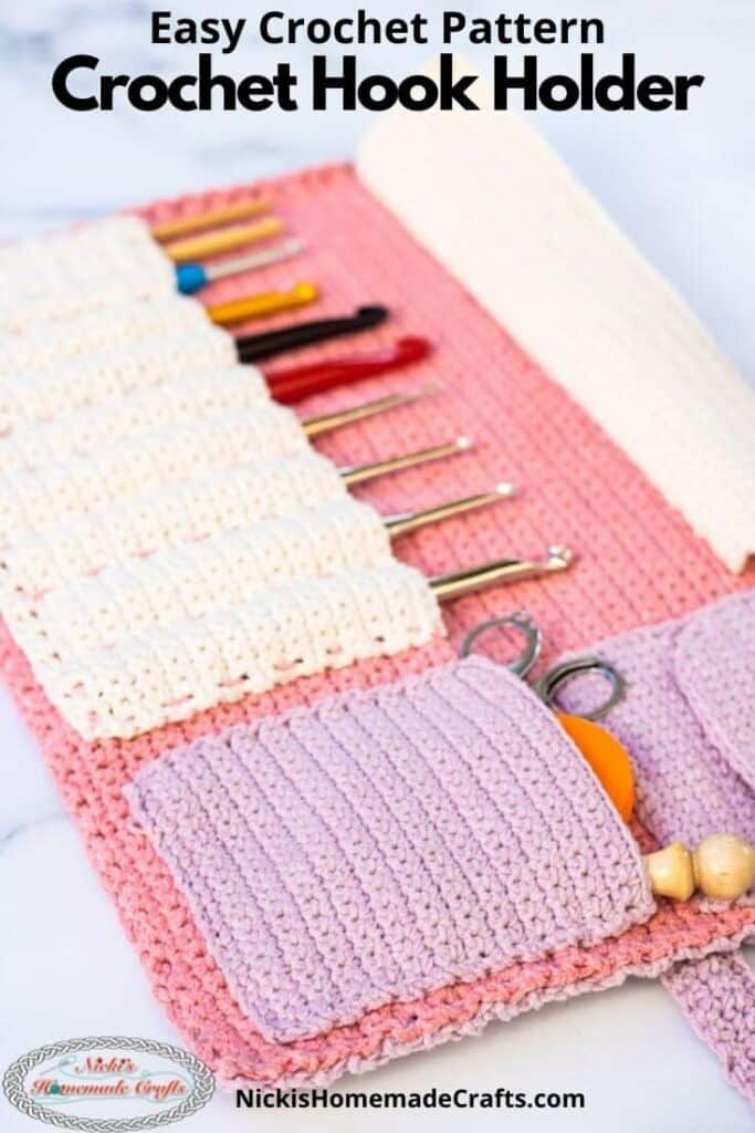 A Pink And White Crochet Purse With Scissors Needles Yarns And Other 